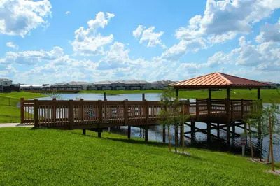 a wooden bridge over a river with a gazebo at Beautiful Lakeview Retreat Near Disney in Kissimmee