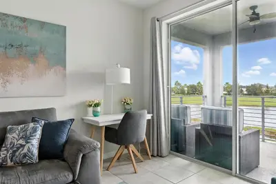 a living room with a couch and a table at Beautiful Lakeview Retreat Near Disney in Kissimmee