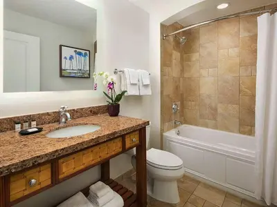 a bathroom with a sink and a toilet and a tub at Sheraton Vistana Villages 2BR Apartment with Resort Access in Orlando
