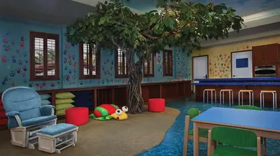 a room with a tree and a table and chairs at Marriott's Lakeshore Reserve Studio Apartment with Resort Access in Orlando