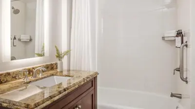 a bathroom with a sink and a tub and a shower at Marriott's Lakeshore Reserve Studio Apartment with Resort Access in Orlando