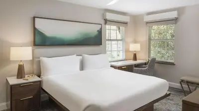 a bedroom with a large bed and a flat screen tv at Marriott's Lakeshore Reserve 1BR Apartment with Resort Access in Orlando