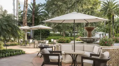 a patio with tables and chairs and a fountain at Marriott's Lakeshore Reserve 1BR Apartment with Resort Access in Orlando