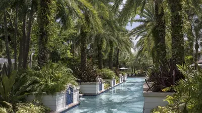 a canal with palm trees and plants in a resort at Marriott's Lakeshore Reserve 1BR Apartment with Resort Access in Orlando