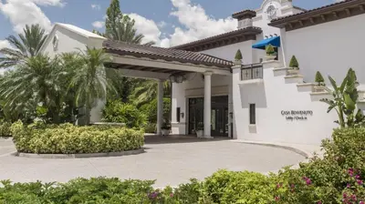 a white house with a porch and a driveway at Marriott's Lakeshore Reserve 1BR Apartment with Resort Access in Orlando