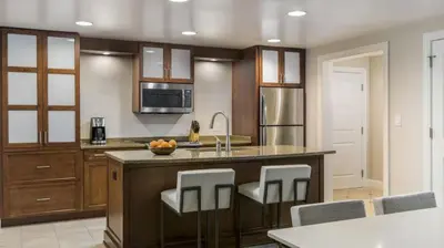 a kitchen with a large island with bar stools at Marriott's Lakeshore Reserve 1BR Apartment with Resort Access in Orlando
