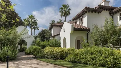 a white house with palm trees and a driveway at Marriott's Lakeshore Reserve 2BR Villa with Resort Access in Orlando