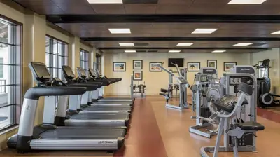 a gym with rows of treadmills and ellipticals at Marriott's Lakeshore Reserve 2BR Villa with Resort Access in Orlando