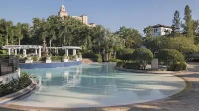 a swimming pool in a park with trees and buildings at Marriott's Lakeshore Reserve 2BR Villa with Resort Access in Orlando