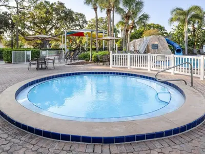 a large swimming pool in a patio with a playground at Sheraton Vistana Resort Two Bedroom Apartment with Resort Access in Orlando