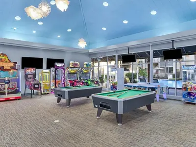 a room with several arcade games and pool tables at Sheraton Vistana Resort Two Bedroom Apartment with Resort Access in Orlando