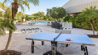a ping pong table in front of a pool at Marriott's Sabal Palms 2BR Apartment with Resort Access in Orlando