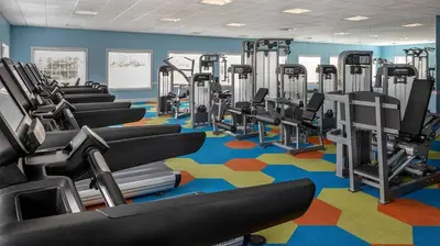 a gym with rows of tread machines on a colorful carpet at Marriott's Harbour Lake Studio Apartment with Resort Access in Orlando