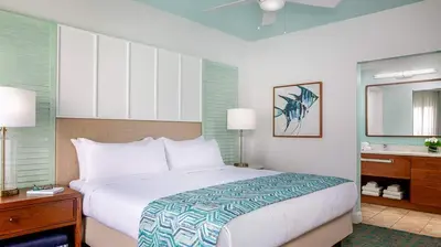 a bedroom with a large bed and a sink at Marriott's Harbour Lake 2BR Apartment with Resort Access in Orlando