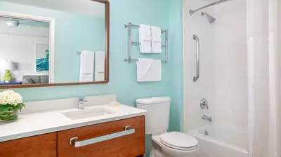a bathroom with a toilet and a sink and a mirror at Marriott's Harbour Lake 2BR Apartment with Resort Access in Orlando
