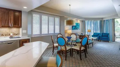 a kitchen and dining room with a table and chairs at Marriott's Royal Palms 2BR Apartment with Resort Access in Orlando