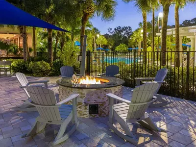 a group of chairs around a fire pit in a patio at Marriott's Royal Palms 2BR Apartment with Resort Access in Orlando