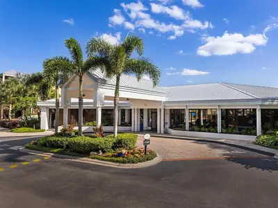 a building with palm trees in front of a street at Marriott's Royal Palms 2BR Apartment with Resort Access in Orlando