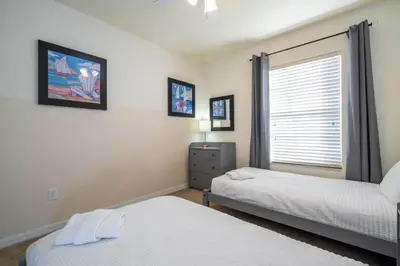 a bedroom with two beds and a window at Charming 3BR Resort Townhome with Private Pool near Disney in Kissimmee