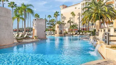 a swimming pool at a resort with palm trees at Marriott's Grande Vista Studio Apartment with Resort Access in Orlando