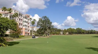 a golf course in front of a large building at Marriott's Grande Vista 1BR Apartment with Resort Access in Orlando