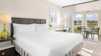 a white bedroom with a large bed and a balcony at Marriott's Grande Vista 1BR Apartment with Resort Access in Orlando