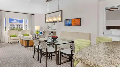 a living room with a table and chairs in a room at Marriott's Grande Vista 2BR Apartment with Resort Access in Orlando