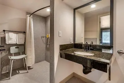 a bathroom with a sink and a mirror at voco Kissimmee Orlando by IHG in Orlando