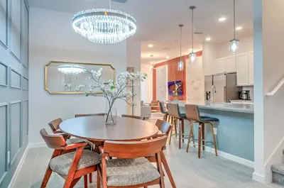 a kitchen and dining room with a table and chairs at 10461 Amazing 5BD Family Townhouse at Paradiso Grande in Orlando