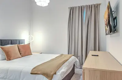 a bedroom with a bed and a table and a window at 10461 Amazing 5BD Family Townhouse at Paradiso Grande in Orlando