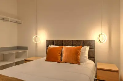 a bedroom with a bed with two lights above it at 10461 Amazing 5BD Family Townhouse at Paradiso Grande in Orlando
