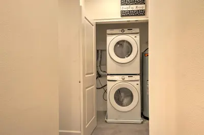 a laundry room with two washer and dryer at 10461 Amazing 5BD Family Townhouse at Paradiso Grande in Orlando