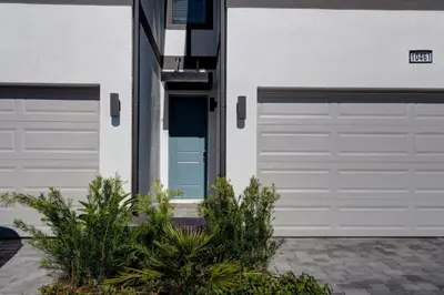 a pair of garage doors on a house at 10461 Amazing 5BD Family Townhouse at Paradiso Grande in Orlando