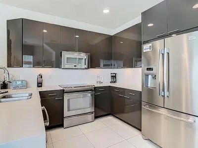 a kitchen with stainless steel appliances and cabinets at Harmony in Orlando