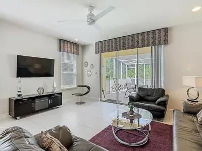 a living room with a couch and a tv at Harmony in Orlando