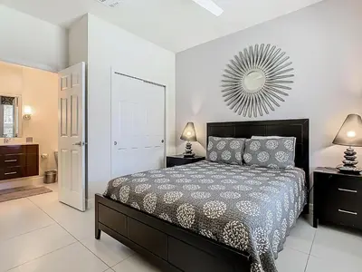a bedroom with a bed and a mirror on the wall at Harmony in Orlando