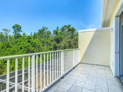 a balcony of a house with trees in the background at Harmony in Orlando