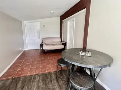 a room with a table and stools and a couch at Spacious Lake Retreat for Families in Saint Cloud