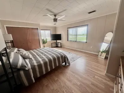 a bedroom with a bed and a ceiling fan at Spacious Lake Retreat for Families in Saint Cloud