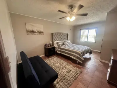 a bedroom with a bed and a ceiling fan at Spacious Lake Retreat for Families in Saint Cloud