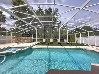 a swimming pool with a pergola over it at Casa del Sol at Indian Creek Four Corners villa in Kissimmee