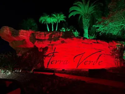 a red sign that reads future venue at night at Disney Universal Theme Home! Private Pool! in Kissimmee