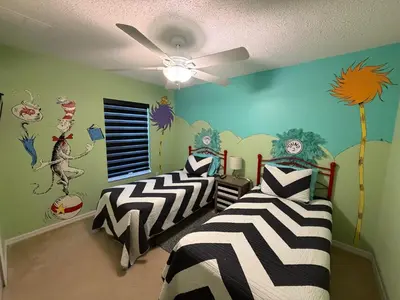 two twin beds in a room with a ceiling at Disney Universal Theme Home! Private Pool! in Kissimmee