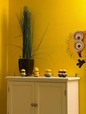 a yellow wall with clocks on top of a cabinet at Disney Universal Theme Home! Private Pool! in Kissimmee