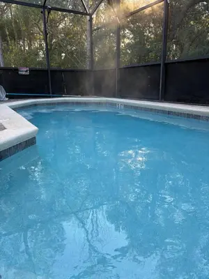a large swimming pool with blue water at Disney Universal Theme Home! Private Pool! in Kissimmee