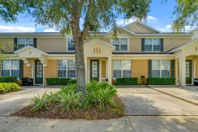 a house with a tree in front of it at Disney Home in Orlando