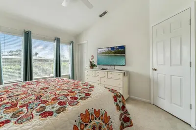 a bedroom with a bed and a flat screen tv at Disney Home in Orlando