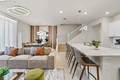 a living room and kitchen with a couch and a table at Brand NEW 05 Bedrooms At Windsor Cay in Orlando