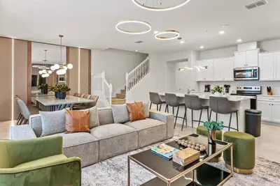 a living room and kitchen with a couch and a table at Brand NEW 05 Bedrooms At Windsor Cay in Orlando