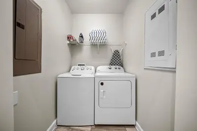 a small kitchen with a white refrigerator and a stove at Brand NEW 05 Bedrooms4 Baths At Storey Lake in Kissimmee
